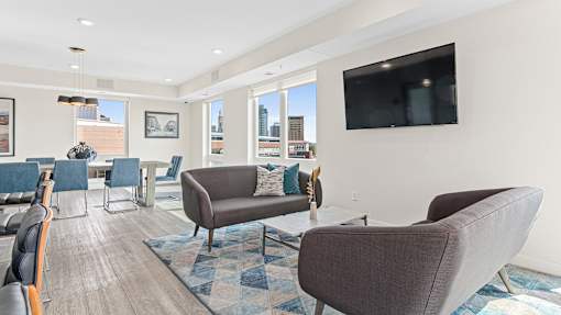 a living room with couches and chairs and a television
