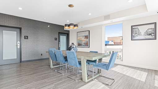 a dining room with a table and chairs