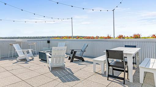 the patio on the top of the building has tables and chairs and views of the