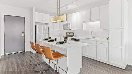 a kitchen with white cabinets and a white counter top
