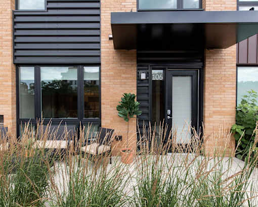 Exterior photo of Oxbo walk out terrace looking into the large exterior facing window.