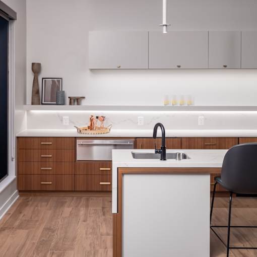 a kitchen with white countertops and wooden cabinets