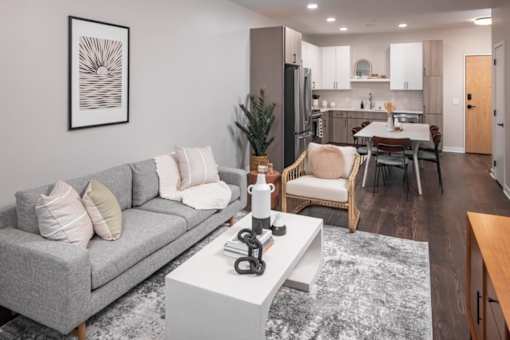 a living room with a gray couch and a white coffee table