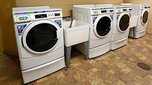 a row of washing machines in a laundromat