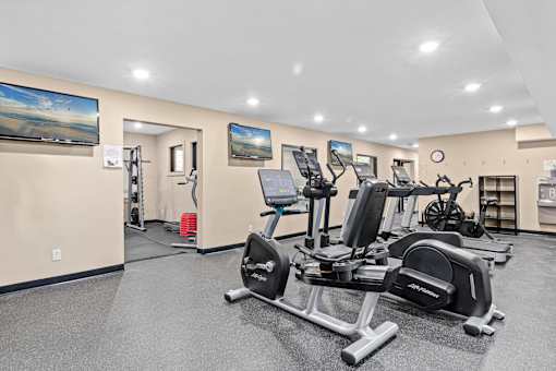 A gym with a row of exercise bikes.