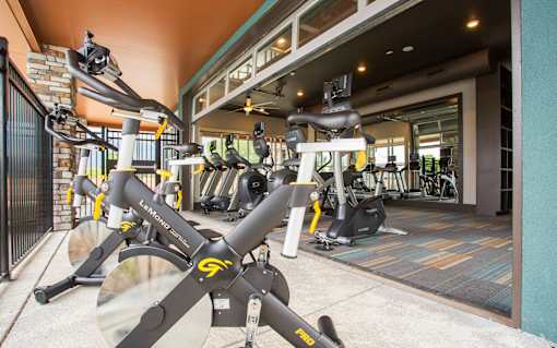 Cycling machines on Fitness Center patio, garage door opens space up