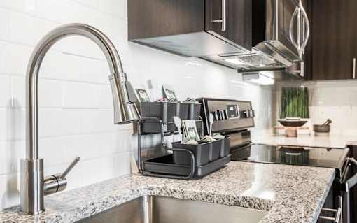 Close up of stainless steel sink and granite countertops