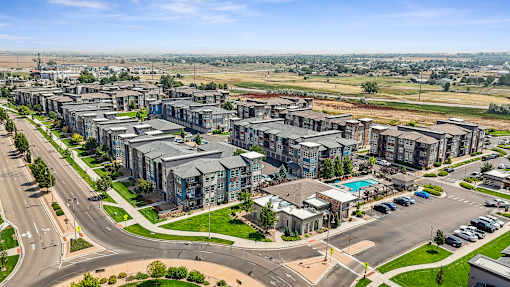 an aerial view of a city with apartment buildings and a highway