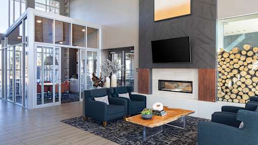 A modern living room with a fireplace and a flat screen TV.
