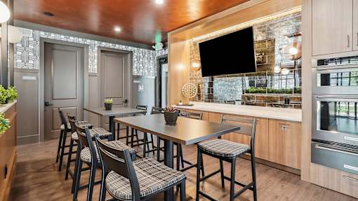 a kitchen with a table and chairs and a television