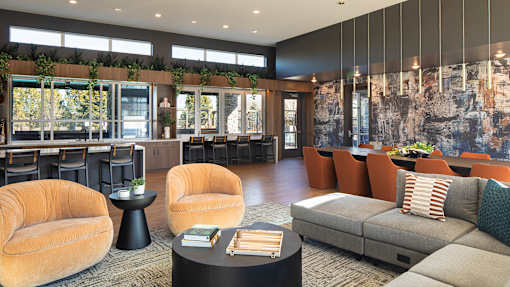 A modern living room with a grey sofa and a black coffee table.