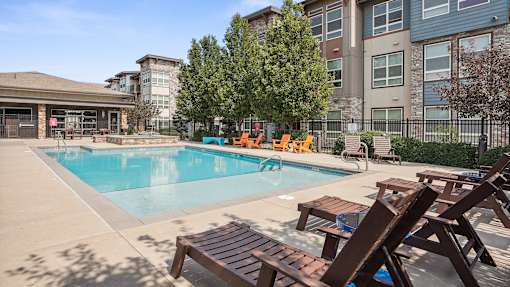 our apartments have a swimming pool with chairs and tables
