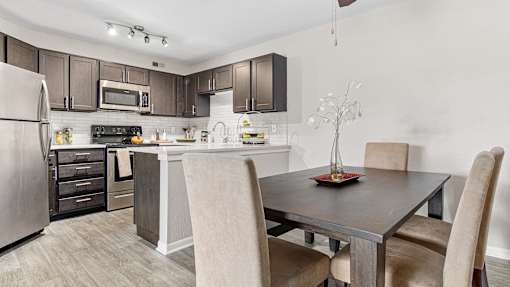a kitchen and dining room with a table and chairs