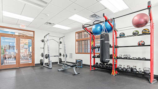 the gym with weights and other equipment at the monarch apartments in des plaines
