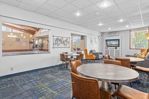 A conference room with a round table and chairs.