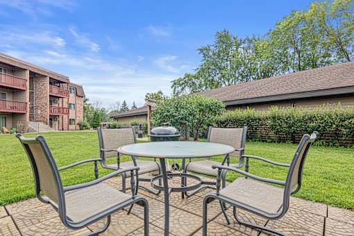 A patio table with chairs is set up outside.