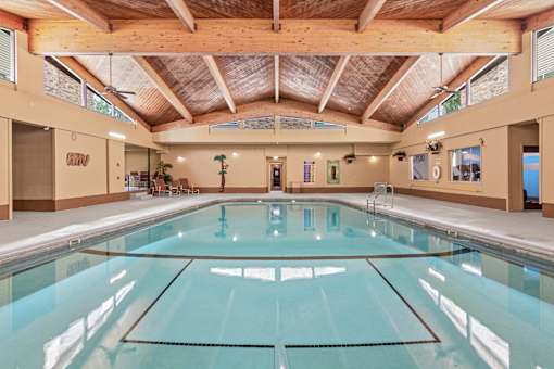A large indoor swimming pool with a glass bottom.