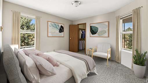 a bedroom with a bed and a chair and a closet