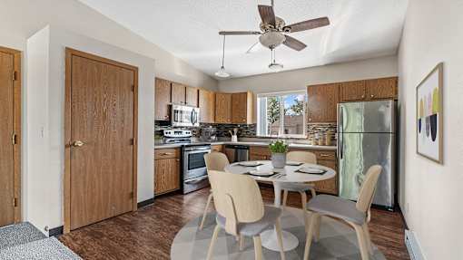 a kitchen and dining room with a table and chairs
