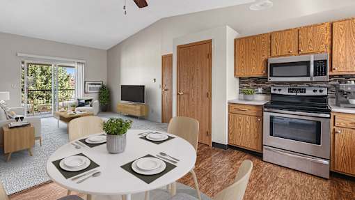 a kitchen with stainless steel appliances and a dining table