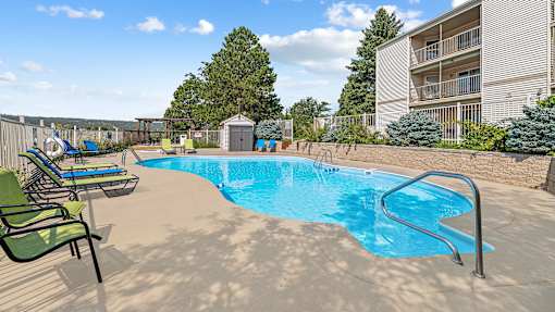 our resort style swimming pool is next to our building with lounge chairs