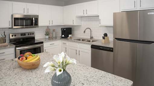 a kitchen with granite counter tops and stainless steel appliances