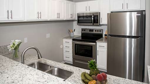 a kitchen with stainless steel appliances and granite counter tops