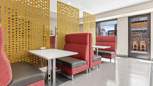 a seating area with chairs and tables in a room