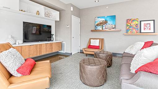 a living room with couches and chairs and a tv