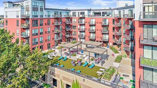 an aerial view of an apartment complex with people in a courtyard