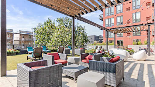 an outdoor patio with chairs and tables and a pergola