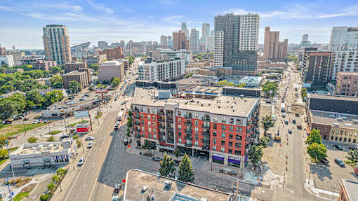 an aerial view of a city street with a red building