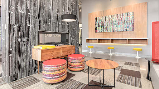 a hotel room with a tv and a table and stool