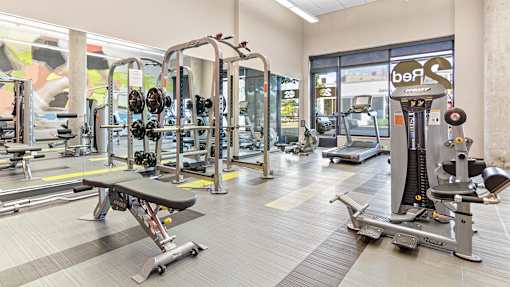a gym with weights and cardio equipment at the monarch apartments in midtown