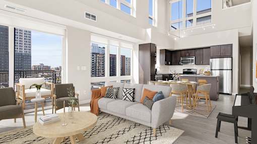 a living room with a couch and a table and a kitchen with a large window