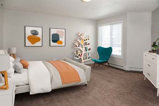 Large bedroom with ample natural light coming from window.