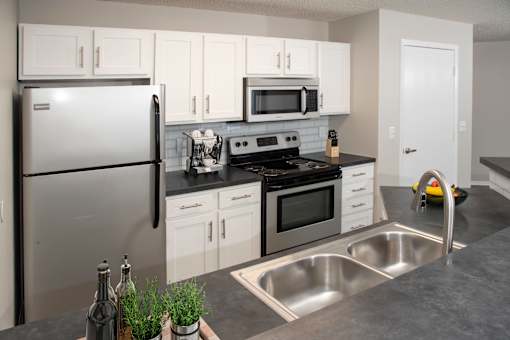 Sleek and modern kitchen with stainless steel finishes and a breakfast bar for casual dining.