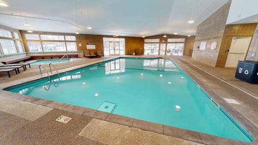 the indoor pool at the resort is heated and has seating around it
