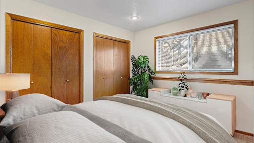 a bedroom with a bed and a window and a closet