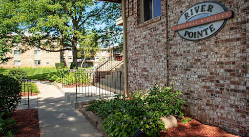 River Pointe sign on brick wall next to entryway