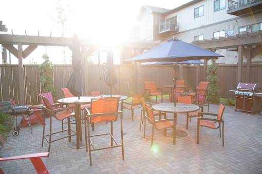 Outdoor Community Patio with Tables and Grill