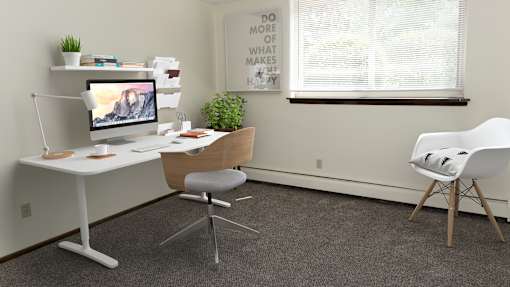 an office with a white desk and chair and a computer