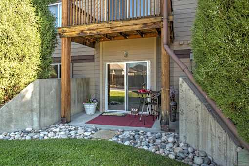 Private Patio with Rock Beds, Sliding Glass Door, and Path to Grass