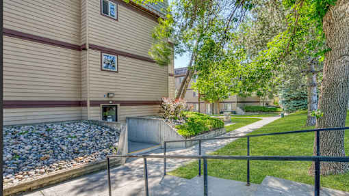 a house with a path and trees in front of it