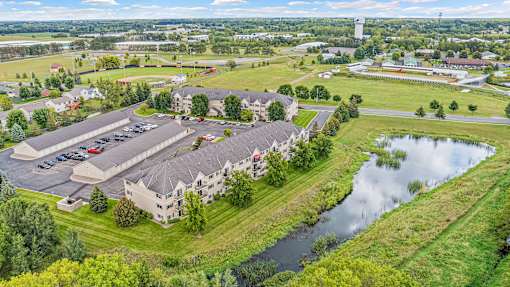 an aerial view of a building next to a body of water