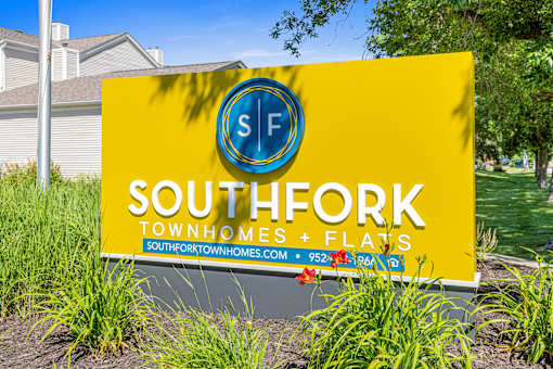 A yellow sign for Southfork Townhomes and Flats.
