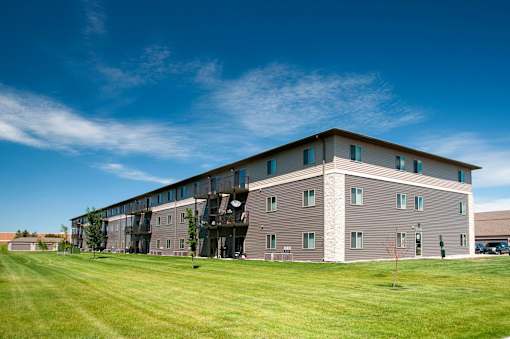 Building exterior with balconies and patio access available in select units.