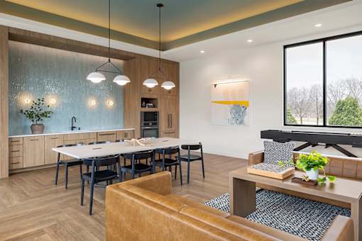 A modern kitchen with a dining table and chairs.