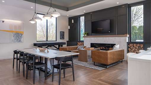 a living room with a table and chairs and a fireplace