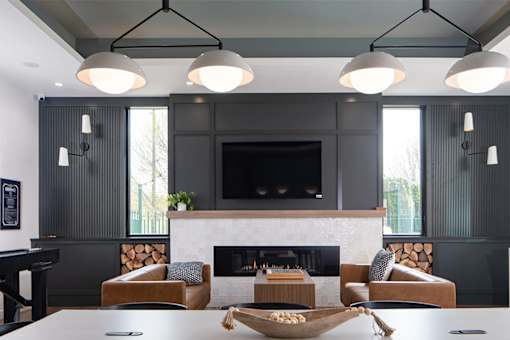 A modern living room with a fireplace and a tv above it.